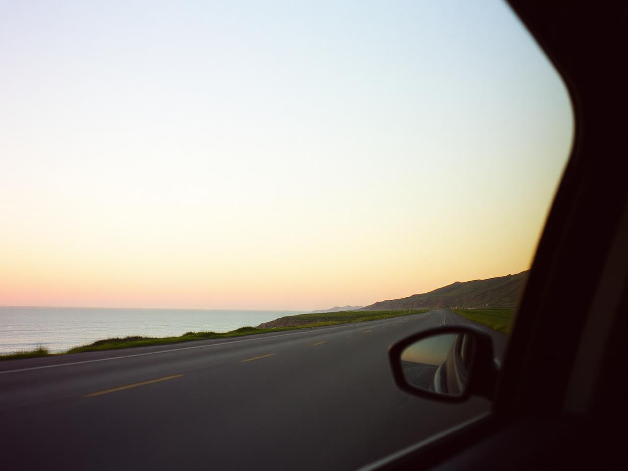Coastal highway at sunrise seen from a car